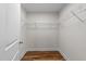 Walk-in closet with built-in shelving and hardwood floors at 640 Barneswyck Dr, Fuquay Varina, NC 27526