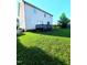 Spacious backyard with a dark deck and a lush green lawn, perfect for outdoor enjoyment at 6701 Winding Arch Dr, Durham, NC 27713