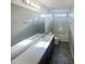 Bright bathroom with double vanity and shower-tub combo at 6701 Winding Arch Dr, Durham, NC 27713