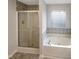 Well-appointed bathroom featuring a separate shower and a luxurious soaking tub for relaxation at 6701 Winding Arch Dr, Durham, NC 27713