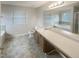Well-lit bathroom with soaking tub and extended vanity space at 6701 Winding Arch Dr, Durham, NC 27713