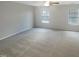 Generously sized bedroom with plush carpeting and natural light streaming through the windows at 6701 Winding Arch Dr, Durham, NC 27713
