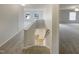 Bright hallway featuring neutral walls, plush carpeting, and natural light from the window at 6701 Winding Arch Dr, Durham, NC 27713