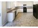 Functional kitchen with sleek appliances, ample counter space, and plenty of storage in the cabinets at 6701 Winding Arch Dr, Durham, NC 27713
