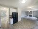 Open kitchen area, transitioning to the living room, and featuring sleek appliances and great natural light at 6701 Winding Arch Dr, Durham, NC 27713