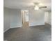Bright living room featuring a ceiling fan and neutral carpeting at 6701 Winding Arch Dr, Durham, NC 27713