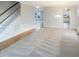 Open-concept living area showcases a seamless blend of carpet and hardwood flooring leading to staircase at 6701 Winding Arch Dr, Durham, NC 27713