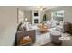 Cozy living room with a fireplace, comfortable seating, and stylish decor. (Virtually staged) at 6701 Winding Arch Dr, Durham, NC 27713
