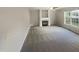Spacious living room featuring a fireplace and large windows that allow natural light to illuminate the area at 6701 Winding Arch Dr, Durham, NC 27713