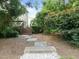 Backyard featuring stepping stones and deck with peaceful setting among the mature landscaping at 705 Harkness Cir, Durham, NC 27705