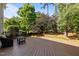 Large backyard deck ideal for gatherings, featuring stylish outdoor seating and backyard view at 705 Harkness Cir, Durham, NC 27705