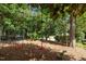 Backyard fun zone including colorful climbing structure and mature shady trees at 705 Harkness Cir, Durham, NC 27705