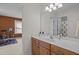 Bathroom vanity with warm wood cabinets and a large mirror at 705 Harkness Cir, Durham, NC 27705