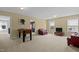Open bonus room with neutral carpet, comfortable seating and a foosball table at 705 Harkness Cir, Durham, NC 27705