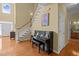 Welcoming entryway with hardwood floors, staircase, and piano creating a grand entrance at 705 Harkness Cir, Durham, NC 27705
