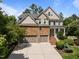 Beautiful two-story home with stone accents, attached two-car garage and manicured lawn at 705 Harkness Cir, Durham, NC 27705