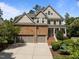 Charming home with stone and siding exterior, 3 car garage and a beautifully landscaped front yard at 705 Harkness Cir, Durham, NC 27705
