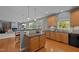 Spacious kitchen boasts wood cabinets, granite countertops, and flows into a cozy living space at 705 Harkness Cir, Durham, NC 27705