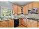 Well-equipped kitchen features stainless steel appliances, granite counters, and wood cabinets at 705 Harkness Cir, Durham, NC 27705