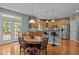 Bright kitchen with stainless appliances, breakfast bar, light wood cabinetry, and hardwood floors at 705 Harkness Cir, Durham, NC 27705