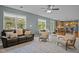 Bright living room with ample natural light, hardwood floors, and open access to the kitchen at 705 Harkness Cir, Durham, NC 27705