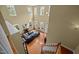 Aerial view of a living room featuring hardwood floors, a fireplace, and multiple large windows at 705 Harkness Cir, Durham, NC 27705