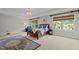 Spacious primary bedroom offers natural light, carpet floors, and a comfortable seating area at 705 Harkness Cir, Durham, NC 27705
