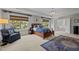 The main bedroom features a tray ceiling, large windows, and ensuite bathroom access at 705 Harkness Cir, Durham, NC 27705
