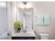 Bathroom features white vanity with silver faucet, green flowers, and pastel towels at 732 Suffield Way, Cary, NC 27519