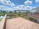 A wood deck with view of pond and neighboring townhomes under a partly cloudy sky at 732 Suffield Way, Cary, NC 27519