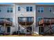 View of the rear exterior of townhomes with decks and patios at 732 Suffield Way, Cary, NC 27519