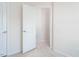 Bright hallway with neutral walls and carpet showcasing an open doorframe at 732 Suffield Way, Cary, NC 27519