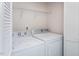 Well-equipped laundry room with modern washer and dryer and ample shelving at 732 Suffield Way, Cary, NC 27519