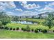 Beautiful pond and view of townhomes under a partly cloudy sky at 732 Suffield Way, Cary, NC 27519