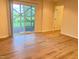 Bright room featuring wood-look flooring and sliding glass door providing access to the outdoors at 732 Suffield Way, Cary, NC 27519