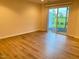Bright room featuring wood-look flooring and sliding glass door providing access to the outdoors at 732 Suffield Way, Cary, NC 27519