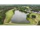Scenic aerial view of a community lake surrounded by lush green trees and beautiful homes at 763 Heritage Arbor Dr, Wake Forest, NC 27587