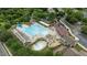 Community pool with multiple areas for swimming and lounging with tables and umbrellas at 763 Heritage Arbor Dr, Wake Forest, NC 27587