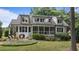 Inviting backyard featuring a cozy patio and manicured landscaping with mature plantings at 763 Heritage Arbor Dr, Wake Forest, NC 27587