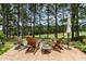 Relaxing backyard features a stone patio with Adirondack chairs overlooking a golf course at 763 Heritage Arbor Dr, Wake Forest, NC 27587