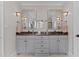 Bathroom features a dual sink vanity with granite countertops and framed mirrors at 763 Heritage Arbor Dr, Wake Forest, NC 27587