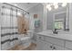 Well-lit bathroom featuring a shower with tile surround, modern vanity, and neutral décor at 763 Heritage Arbor Dr, Wake Forest, NC 27587