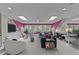 Bright bonus room with skylights, pink accent wall, and comfortable seating area at 763 Heritage Arbor Dr, Wake Forest, NC 27587