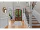 Bright foyer featuring hardwood floors, staircase, and large front doors with sidelights at 763 Heritage Arbor Dr, Wake Forest, NC 27587