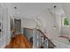 Upstairs hallway with hardwood floors, pendant lights, and white trim at 763 Heritage Arbor Dr, Wake Forest, NC 27587
