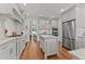 Spacious kitchen with white cabinets, marble countertops, and stainless steel appliances at 763 Heritage Arbor Dr, Wake Forest, NC 27587