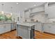 Bright kitchen featuring white cabinets, marble countertops, and stainless steel appliances at 763 Heritage Arbor Dr, Wake Forest, NC 27587