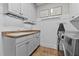 Laundry room with white cabinets, countertop, and stainless steel washer and dryer at 763 Heritage Arbor Dr, Wake Forest, NC 27587