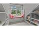Charming window seat with pink cushions nestled between built-in shelves and large windows at 763 Heritage Arbor Dr, Wake Forest, NC 27587