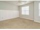 Neutral bedroom with carpet, windows, and white wainscoting at 7646 Winners Edge St, Raleigh, NC 27617